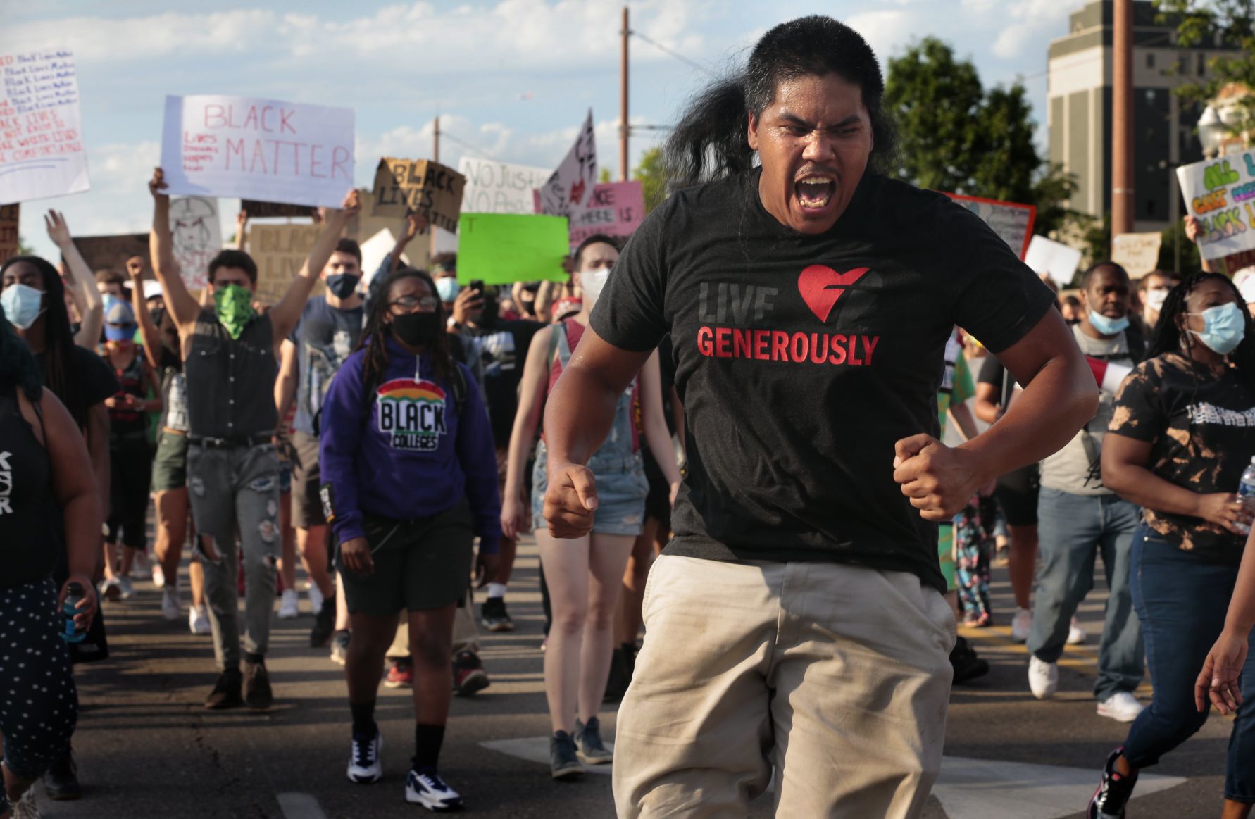 Protesters march through the Delmar Loop
